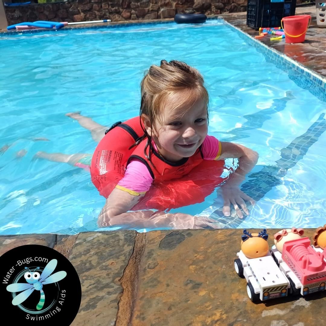 Girl at pool edge smiling up with Water-Bugs