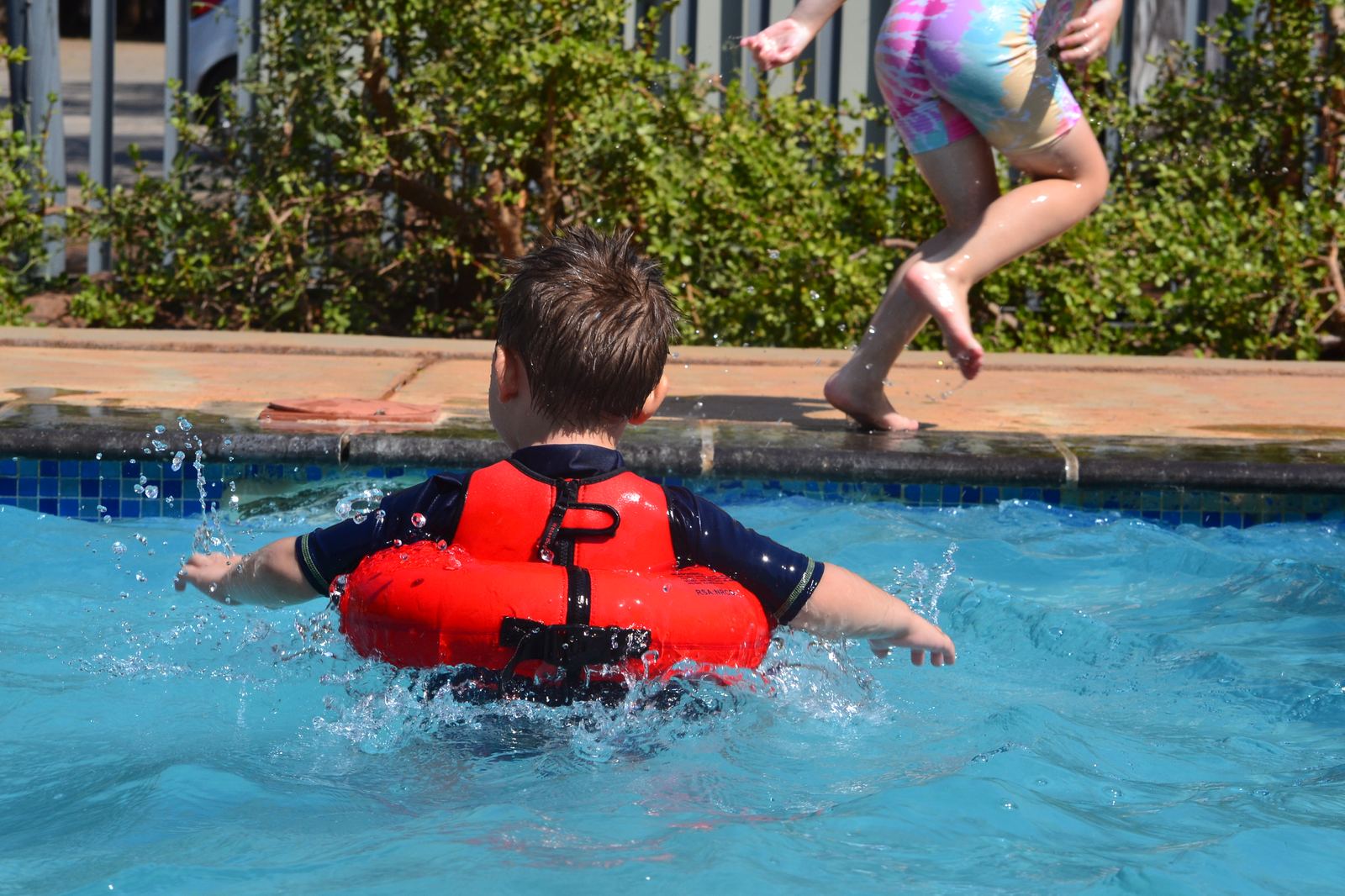 Child swimming confidently in Water-Bugs float